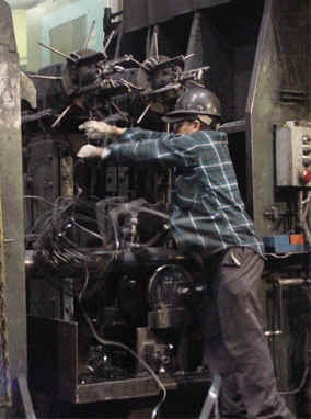 Tube mill operator fighting with scarf ball.